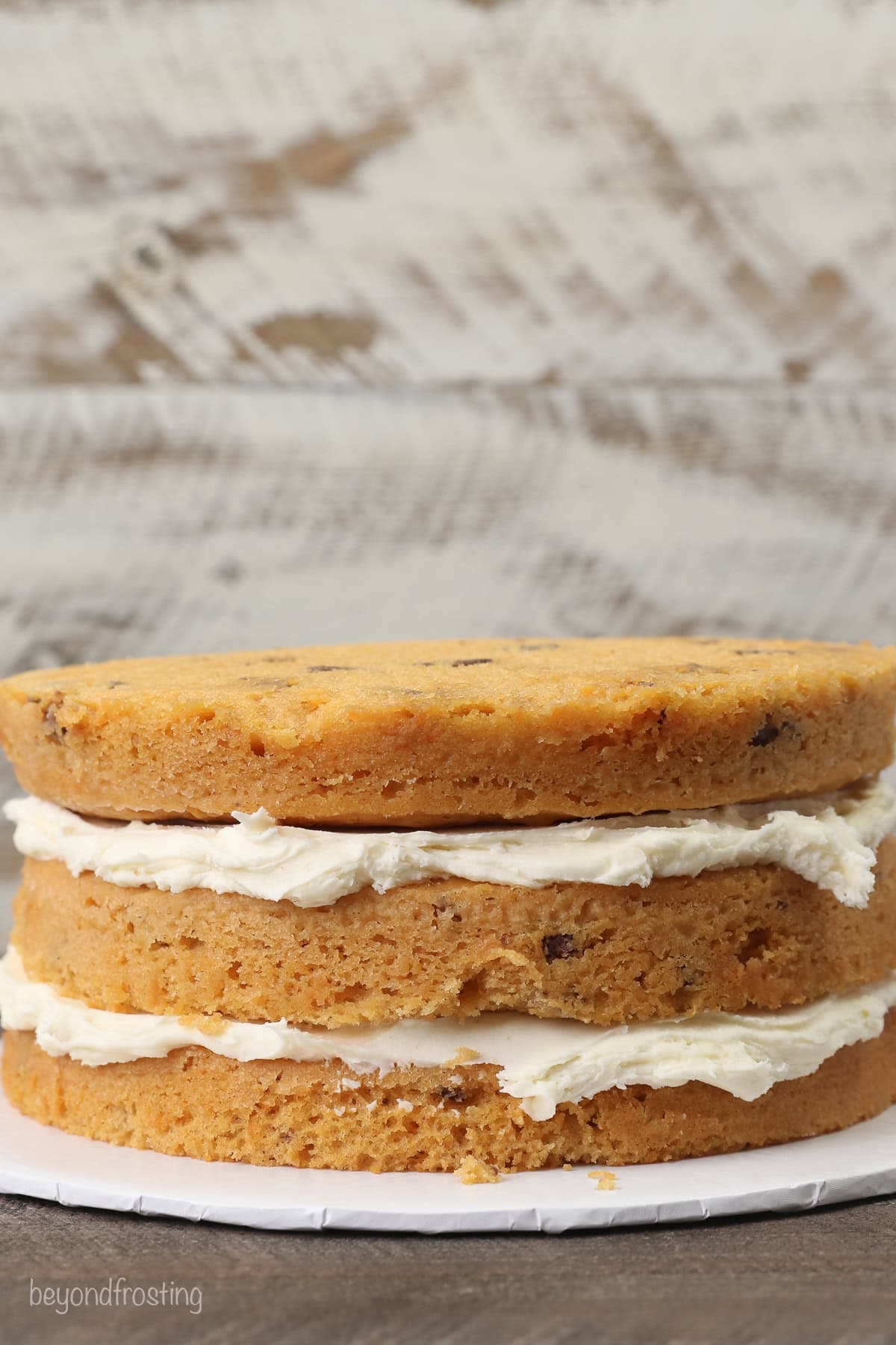 Three butterscotch cake layers stacked and filled with brown butter frosting.