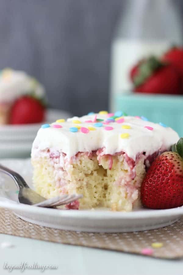 A pretty slice of strawberry cake with a bite taken out of it