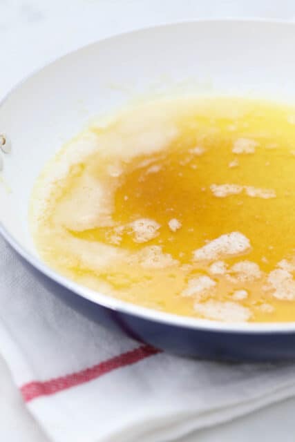 Butter melting in a shallow saucepan.