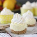 A mini frozen lemon pie without a wrapper showing the crust, the filling and the whipped topping