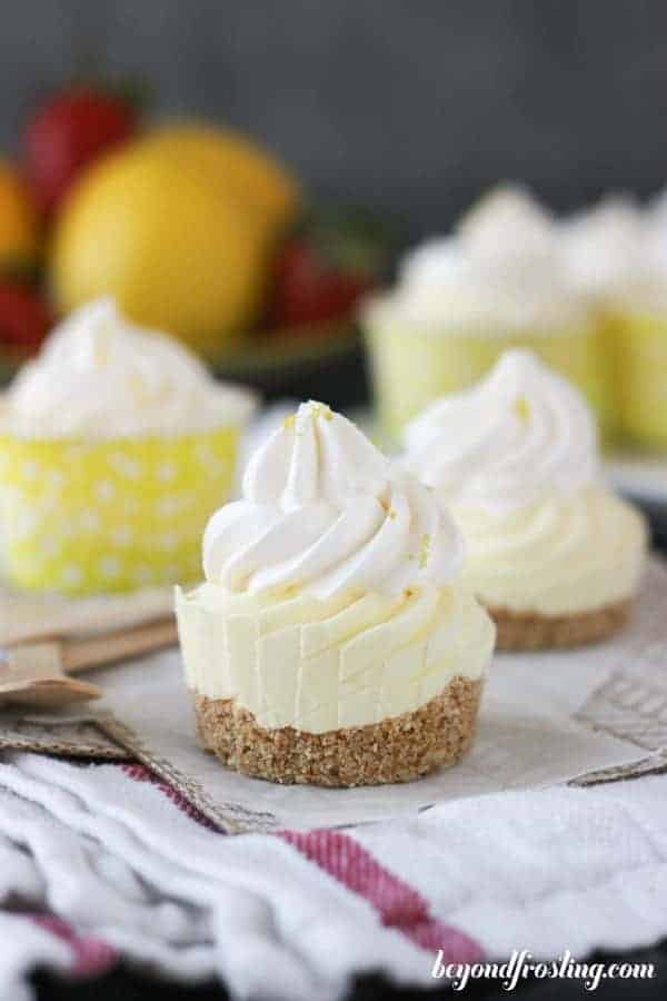 A mini frozen lemon pie without a wrapper showing the crust, the filling and the whipped topping