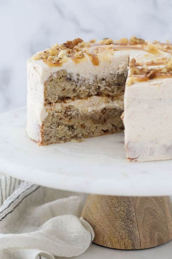 A two layer banana cake on a marble cake stand