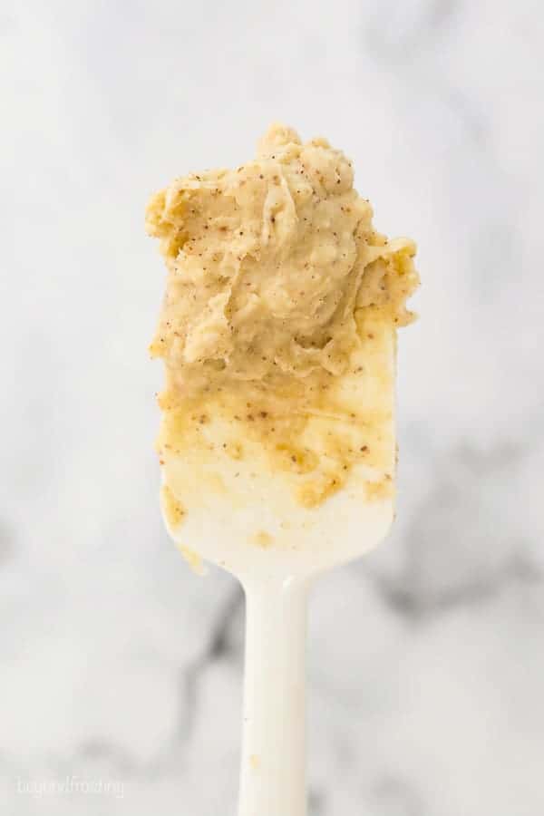 A white spatula with whipped brown butter