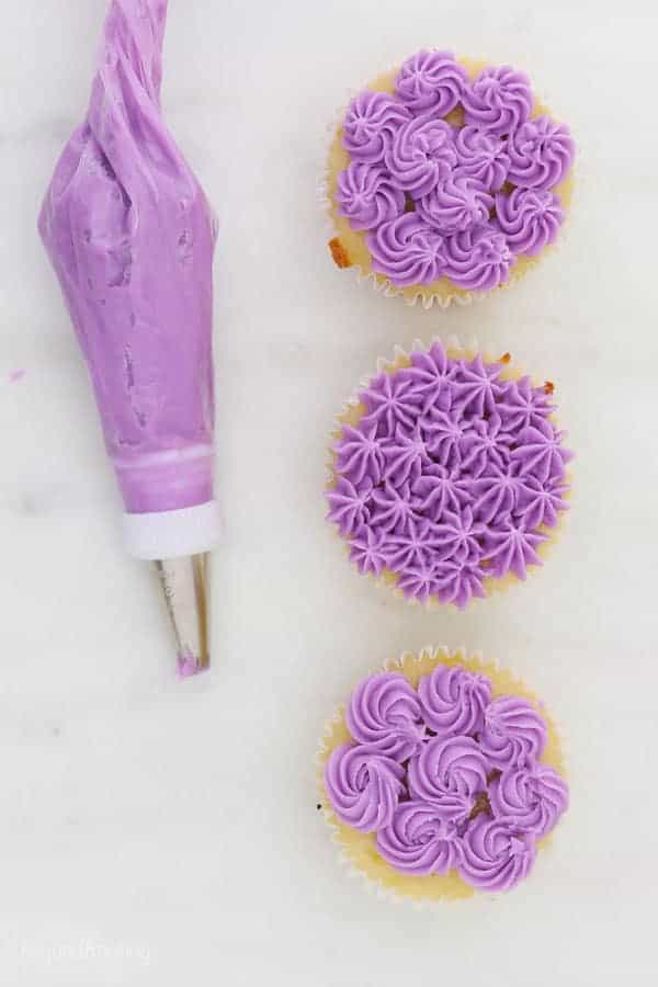 an open star piping tip used in 3 ways to show decorated cupcakes