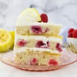 A slice of lemon raspberry cake on a pink plate