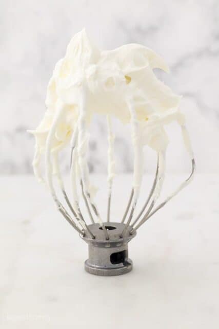 A KitchenAid wire whisk with Mascarpone Whipped Cream