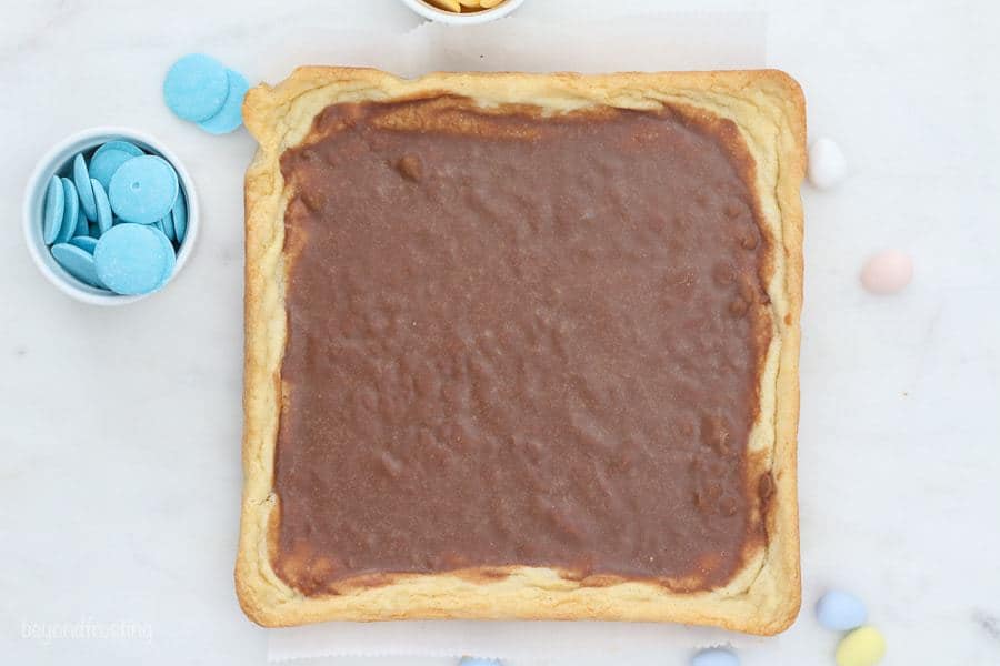 An overhead view of a cookie bar spread with ganache