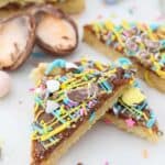 A colorful, decorated sugar cookie bar with Cadbury Mini Eggs