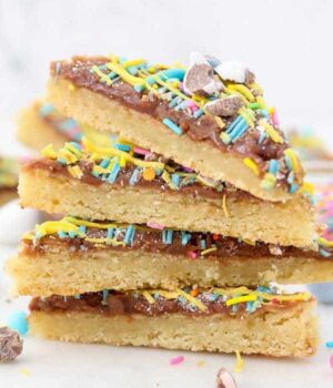 A stack of 4 Easter sugar cookie bars with sprinkles on top