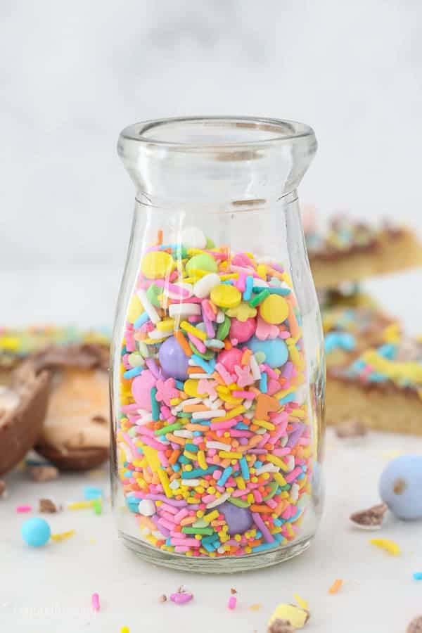 A small glass jar filled with sprinkles