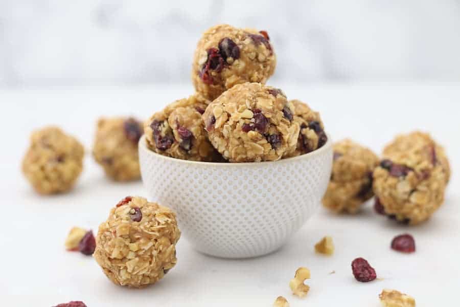 A wide shot of a bowl of protein bites with cranberries and walnuts