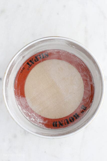 Overhead view of an 8-inch cake pan lined with a round silicone mat.