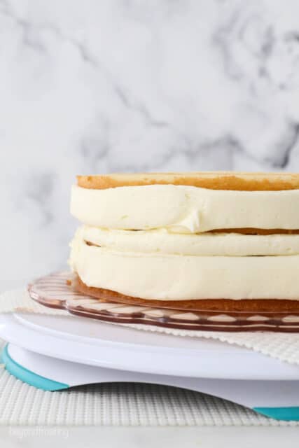 Frosting piped around the sides of a double-layer cake.