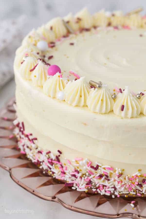 A gorgeous frosted cake with pink and white sprinkles