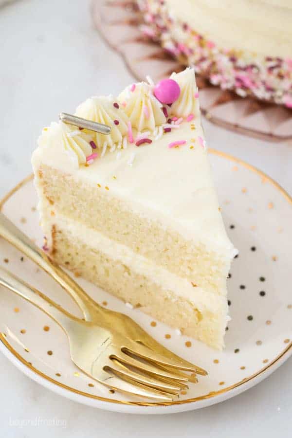 A slice of vanilla cake with pink sprinkles