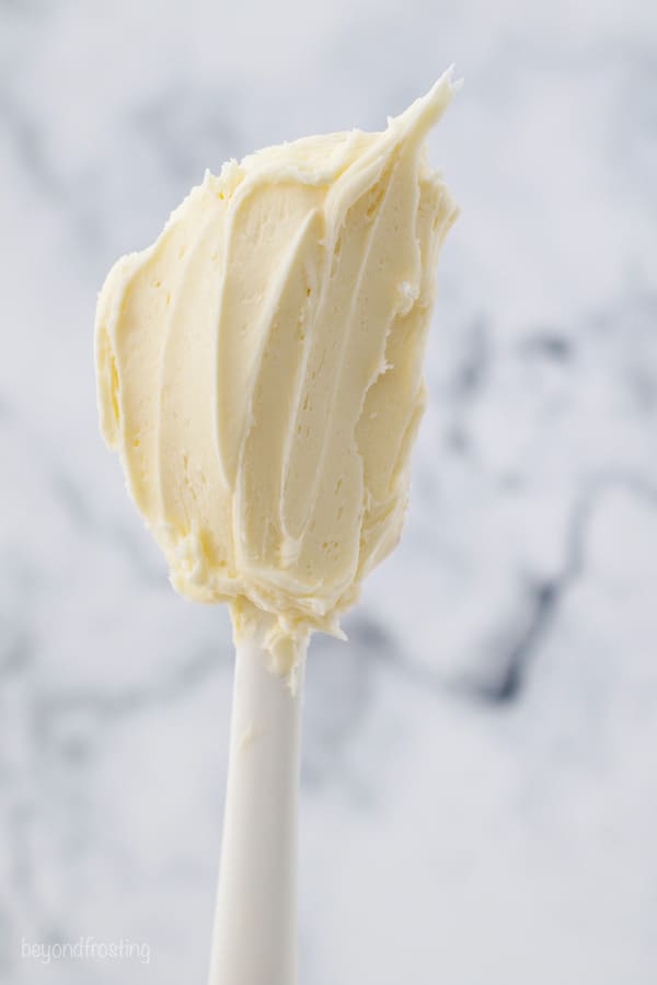 A white spatula with buttercream on it