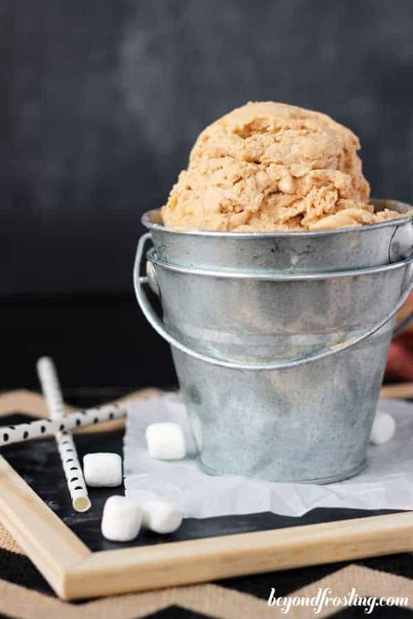 a silver bucket filled with sweet potato ice cream, and mini marshmallows on the side