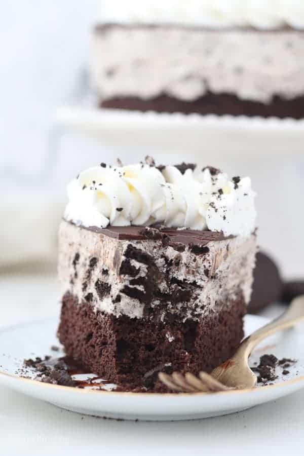 A slice of oreo ice cream cake with a couple bite missing