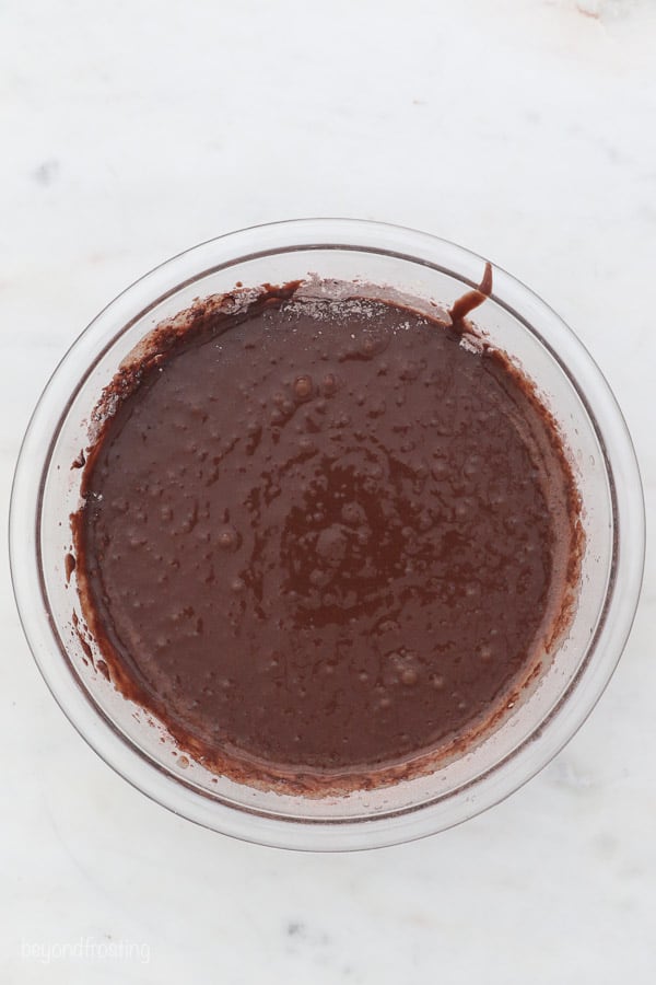 a clear glass bowl with chocolate cake batter