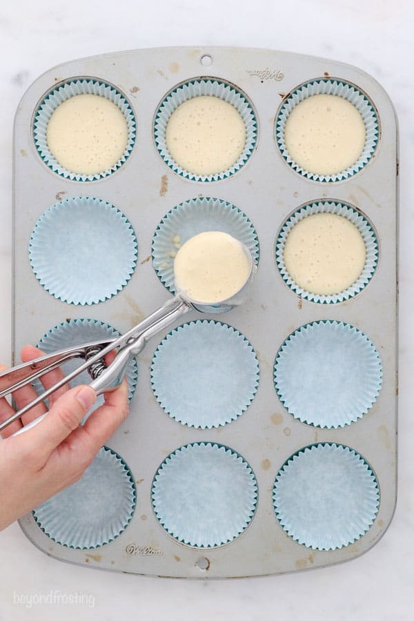 an overhead shot filling cupcake liners with a cookie scoop