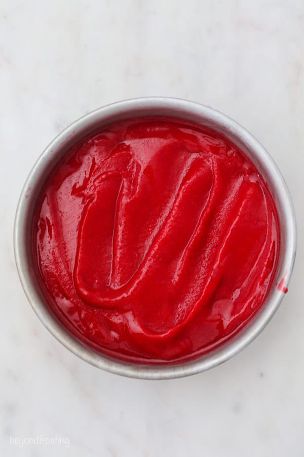 an overhead shot of raspberry sorbet in a round cake pan