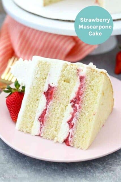 A slice of vanilla cake with strawberry filling on a pink plate with a text overlay