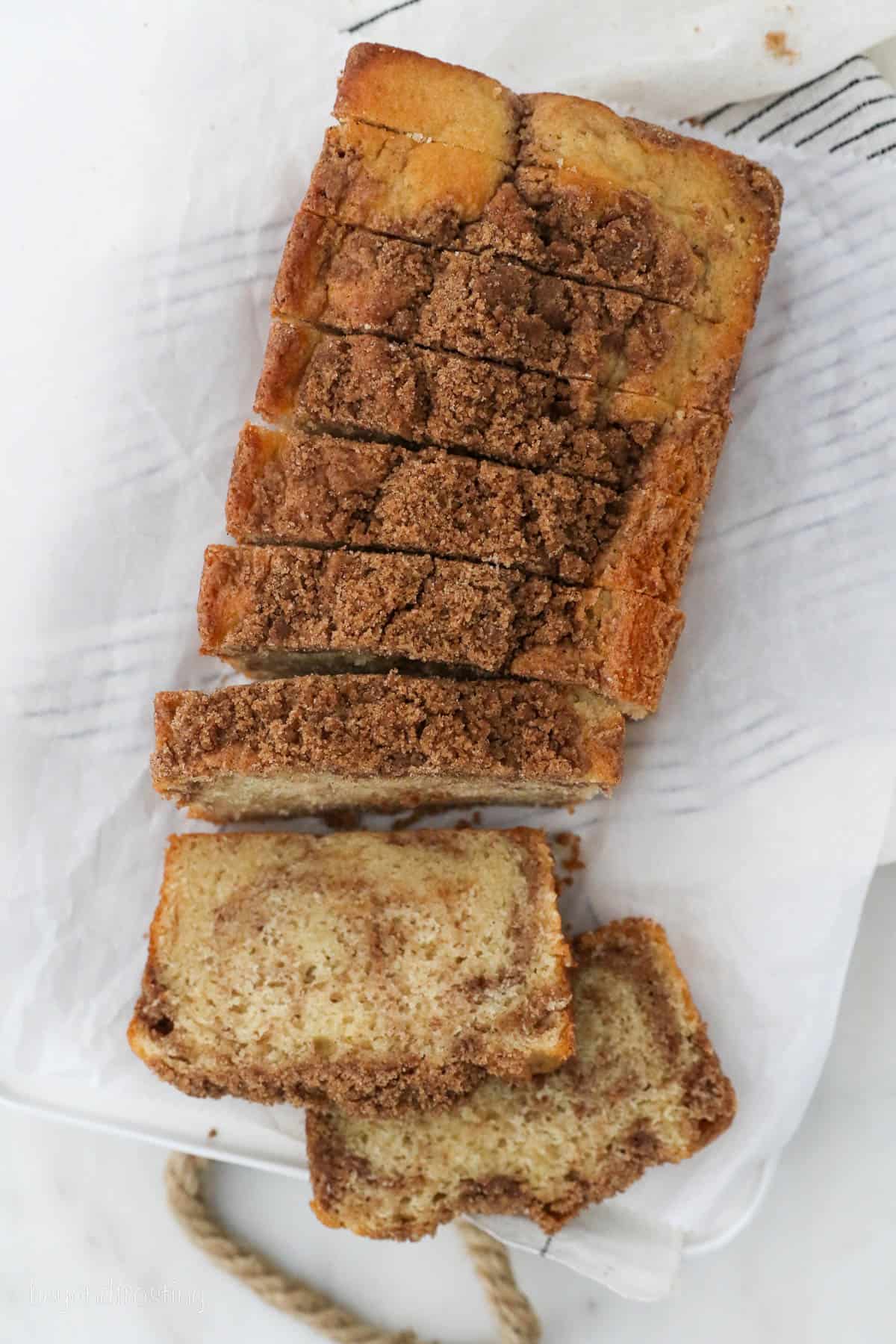 Overhead view of a loaf of cinnamon sugar bread cut into slices.