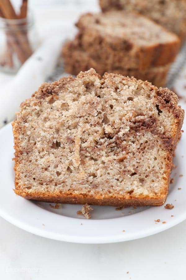 sliced apple bread on a white plate showing the streusel in the middle