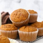 pumpkin muffins stacked on a wire cooling rack