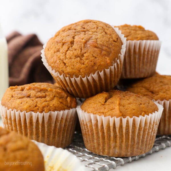 Close up of a pile of pumpkin muffins on a plate.