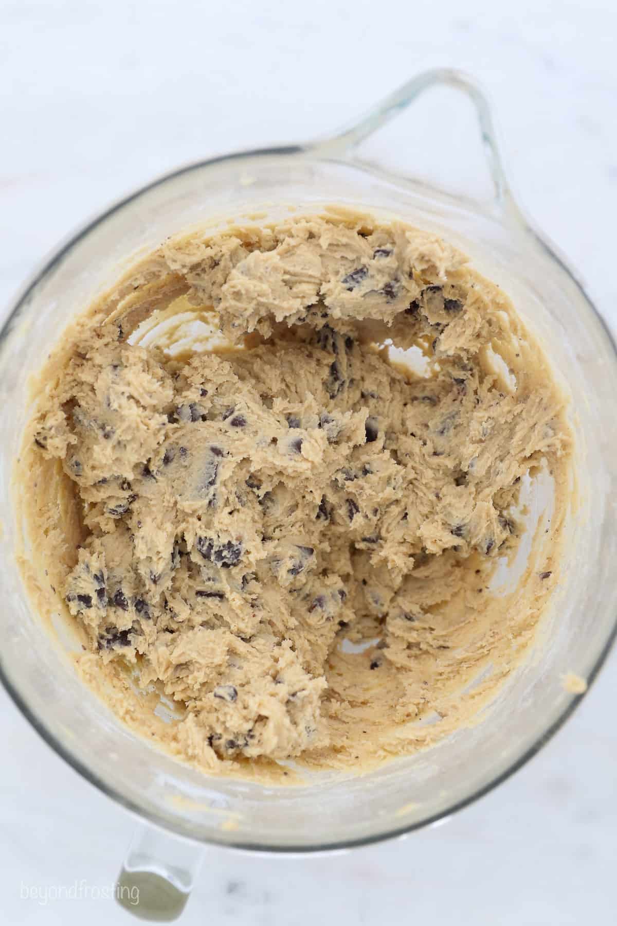 Chocolate chip cookies dough in a glass bowl.