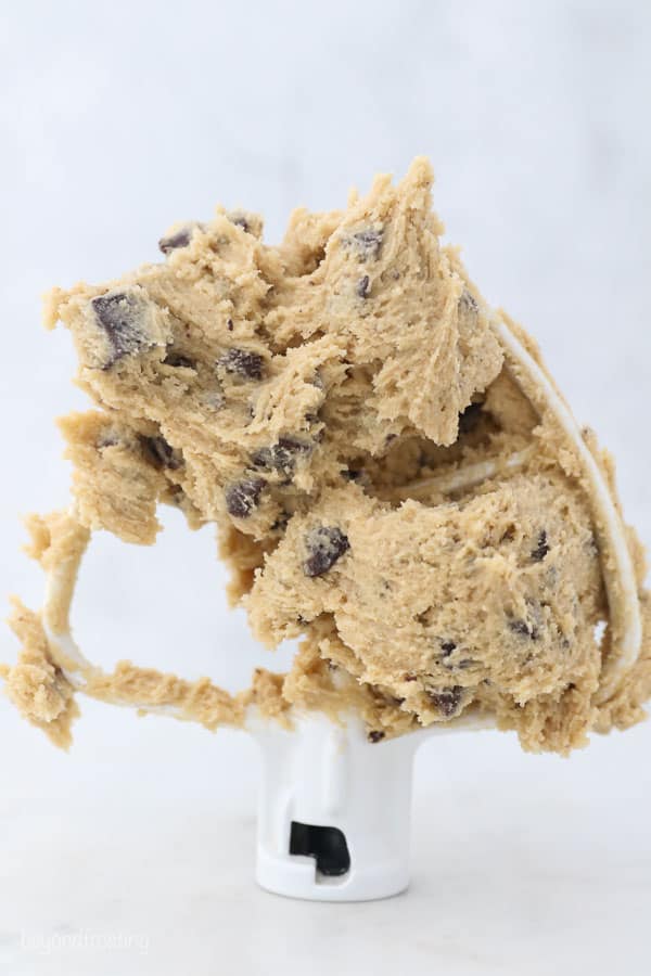 A paddle attachment for a mixer filled with cookie dough