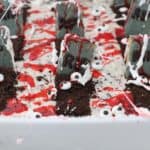 A close up shot of a candy graveyard with headstones and fake blood