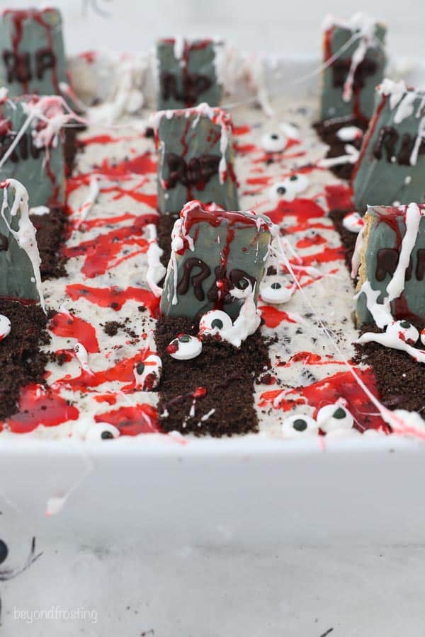 A close up shot of a candy graveyard with headstones and fake blood