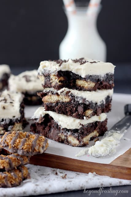 A Stack of Three Samoa Stuffed Brownies in Front of a Glass of Milk