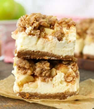 Two caramel apple cheesecake bars stacked on top of one another.