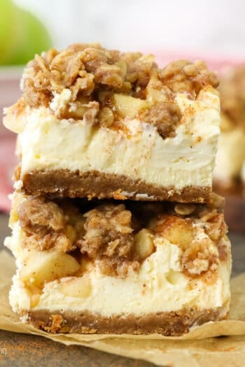 Two caramel apple cheesecake bars stacked on top of one another.