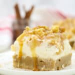 A close up of an apple cheesecake bar on a plate