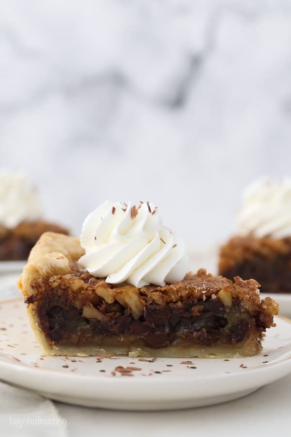 A side view of a slice of chocolate walnut pie