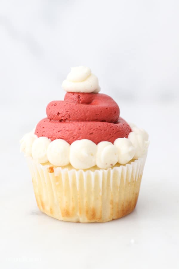 Vanilla cupcake decorated to look like a Santa hat