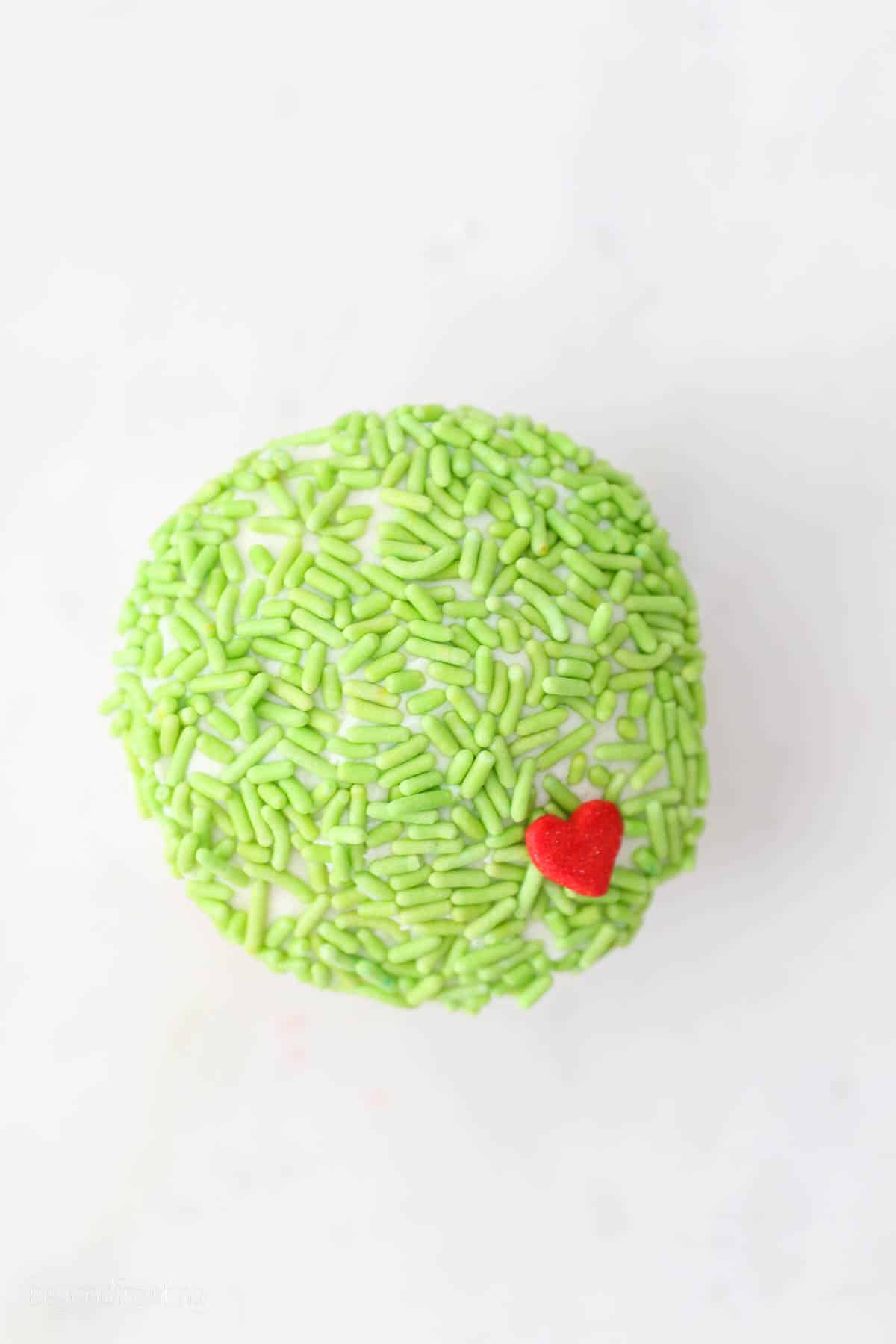Overhead view of a cupcake decorated to look like the Grinch.