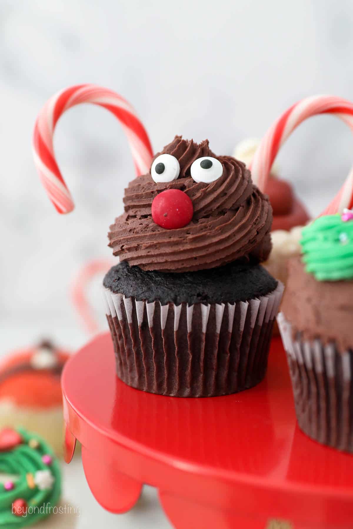 A chocolate cupcake decorated to look like a reindeer.