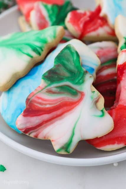 A Christmas tree sugar cookie decorated with marble icig