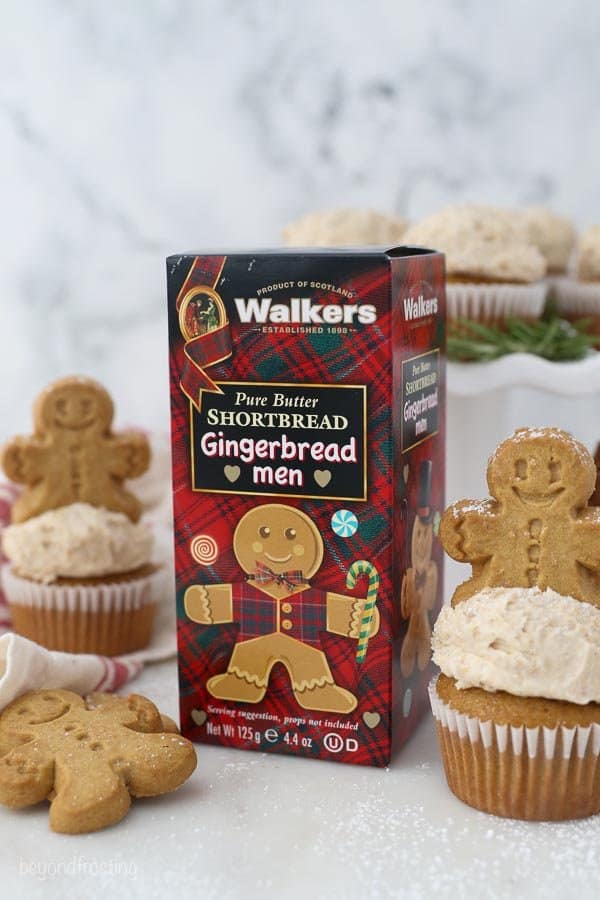 A box of Walkers Gingerbread Men Shortbread cookies along side Gingerbread cupcakes