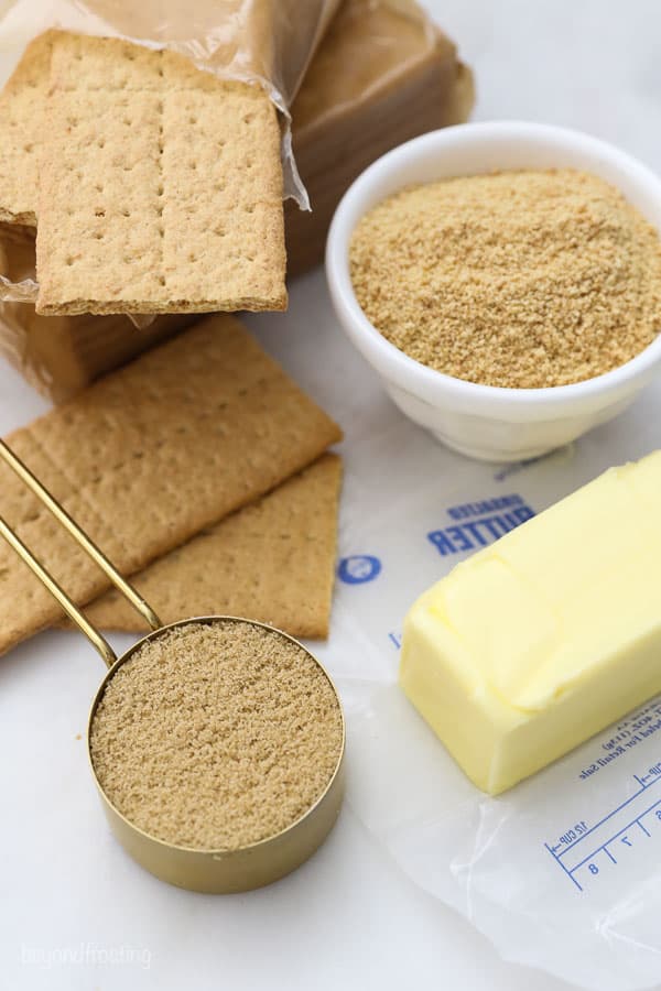 ingredients for a graham cracker pie crust- brown sugar, butter and graham cracker crumbs