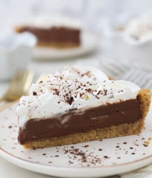 A slice of chocolate pudding pie topped with whipped cream