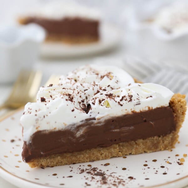 A slice of chocolate pudding pie topped with whipped cream
