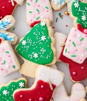 Assorted cut-out Christmas sugar cookies decorated with sugar cookie icing.