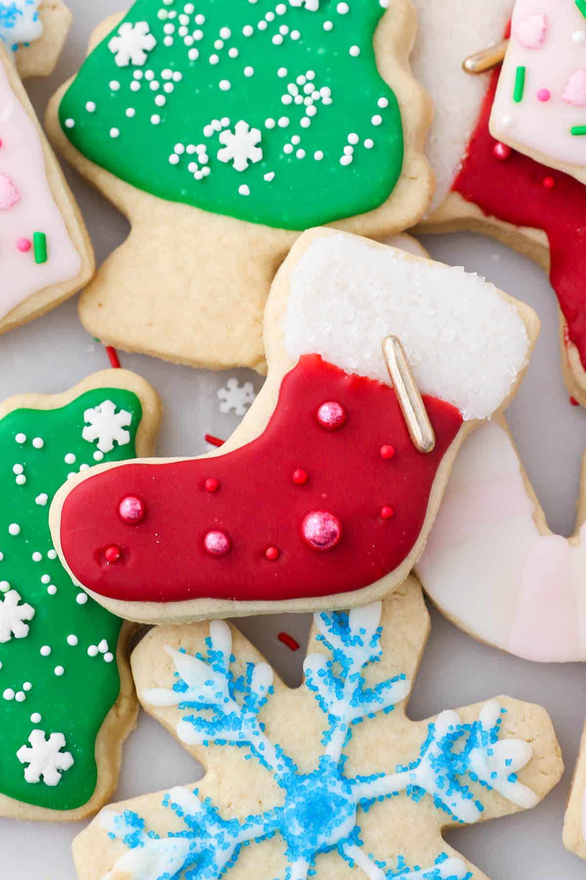 Assorted cut-out Christmas sugar cookies decorated with sugar cookie icing.