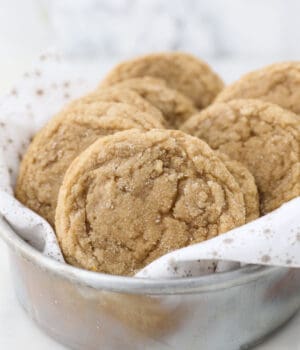 A vintage metal round pan filled with cookies